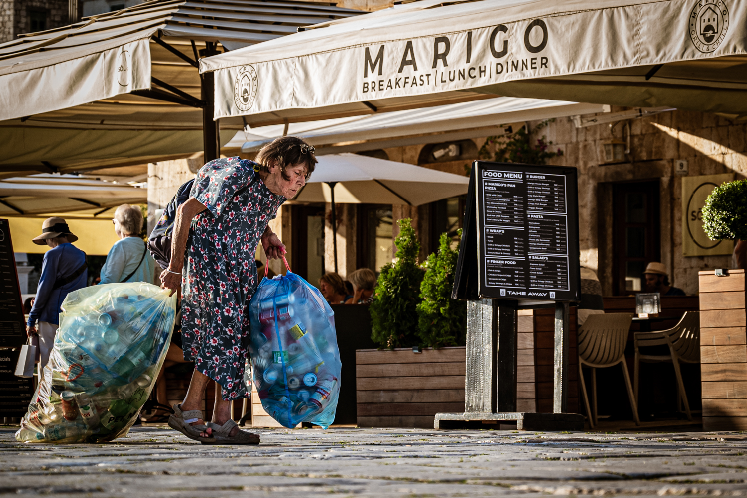 A woman collecting plastic bottles